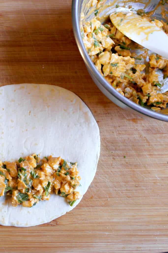 filling the tortillas cheesy buffalo pinwheels