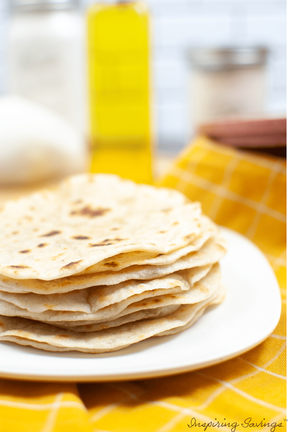 Easy Homemade Corn Tortillas - homemade tortillas stacked on white plate