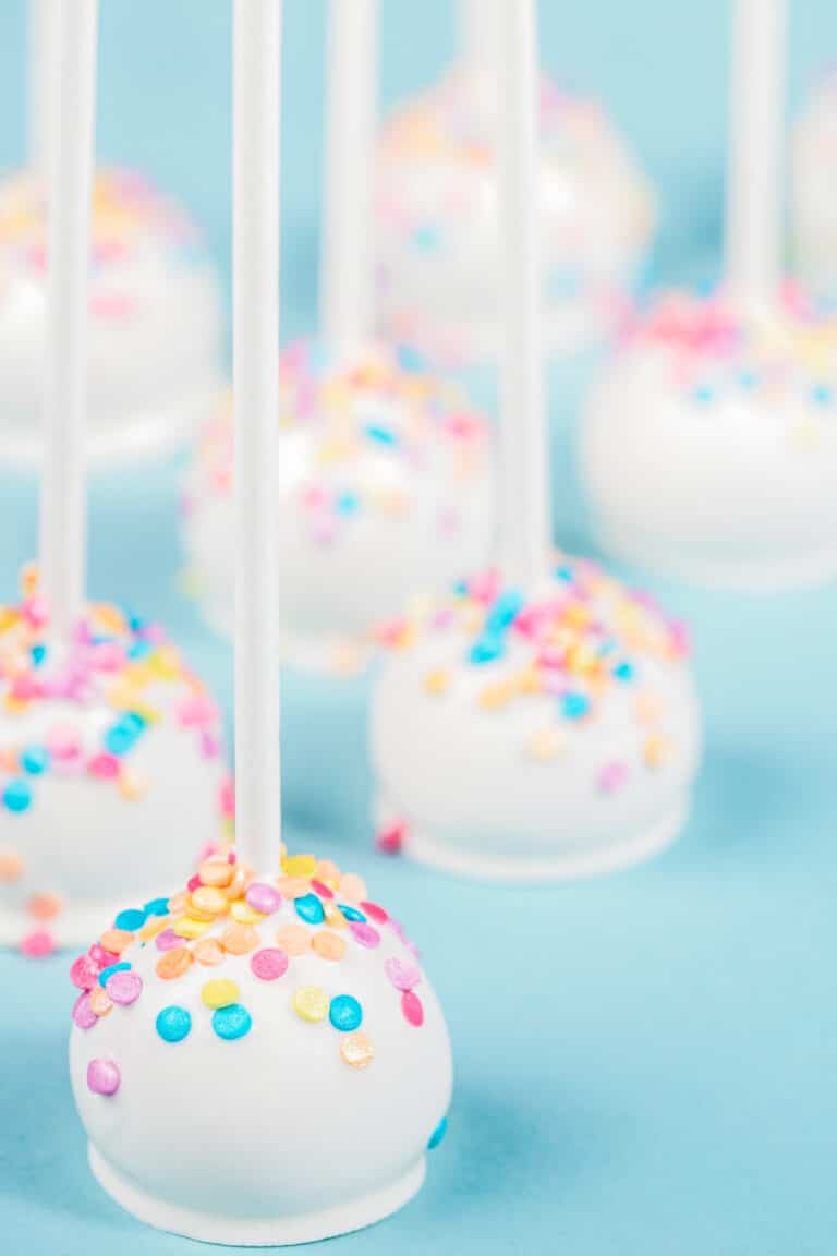 vanilla cheesecake cake pops on blue background