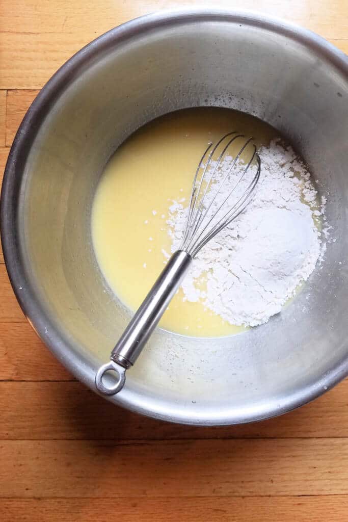 Mixing wet and dry ingredients in bowl for dinner rolls