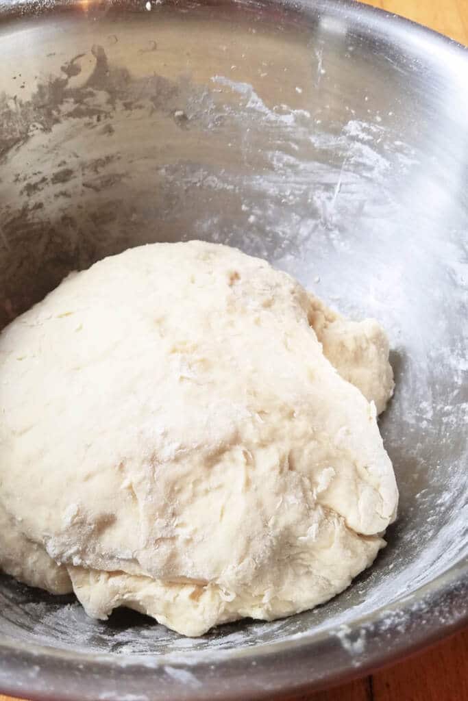 dough ball in large bowl ready to be proofed