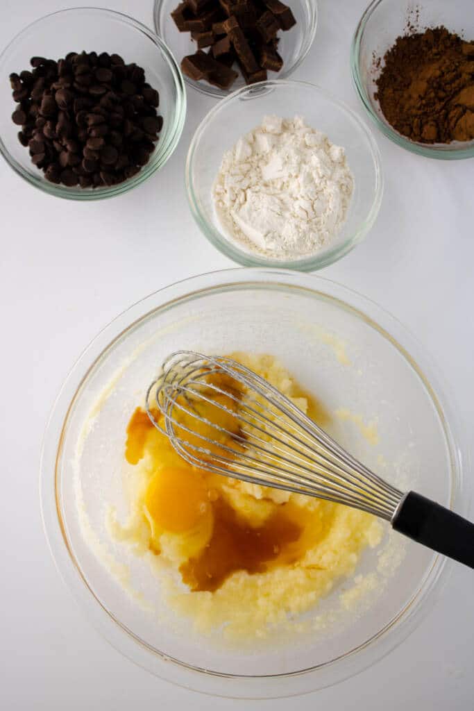 mixing eggs into sugar and butter mixture - wet ingredients