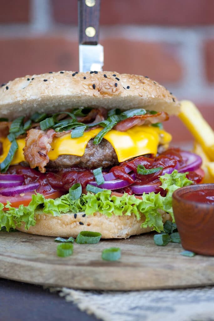 Double Stacked Cheeseburger with knife and ketchup