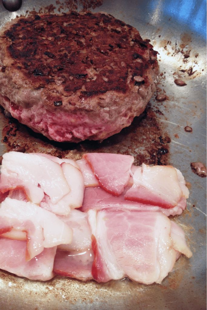 cooking burger and bacon in pan