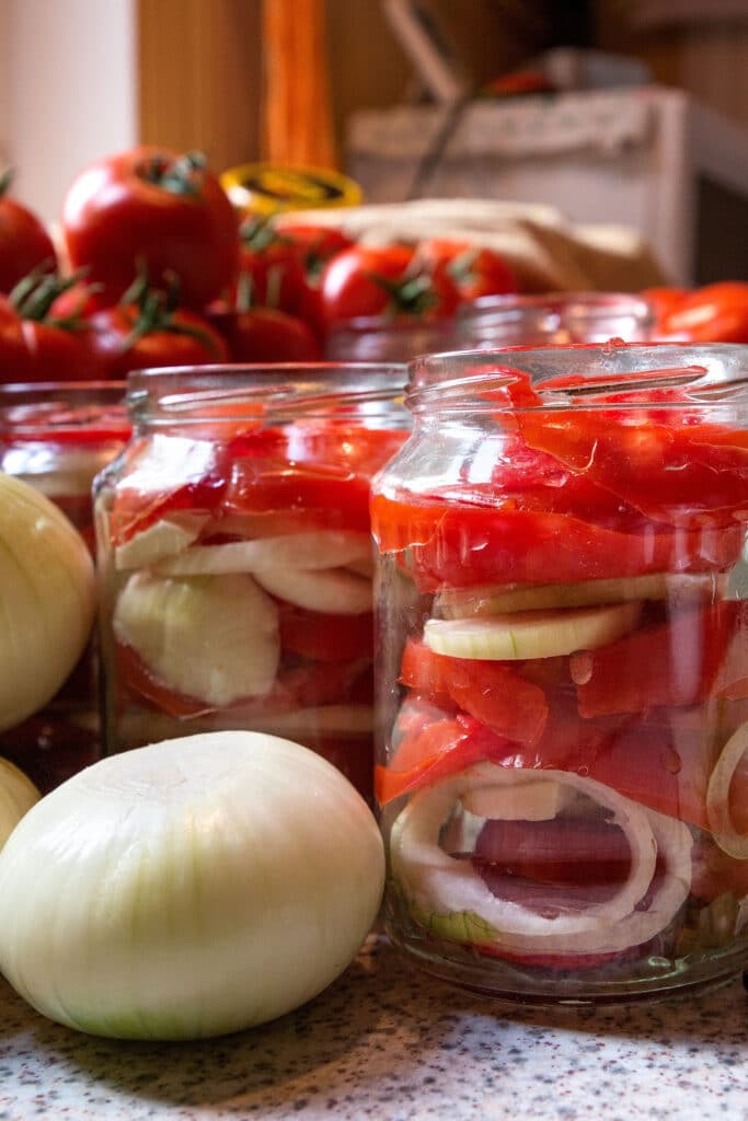 canning food - tomatoes and onions in canning jars from local growers