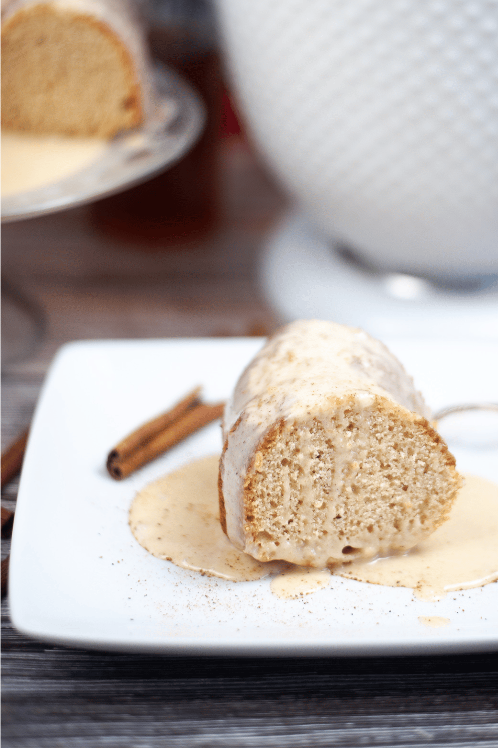 eggnog Bundt cake piece on white plate with eggnog glaze ready to be served