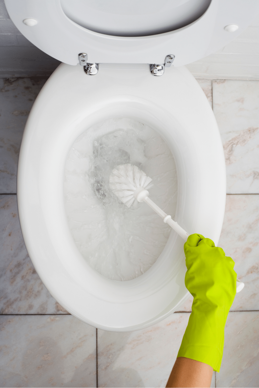 cleaning toilet with an alka seltzer tablet. Pictured woman scrubbing toilet with toilet brush